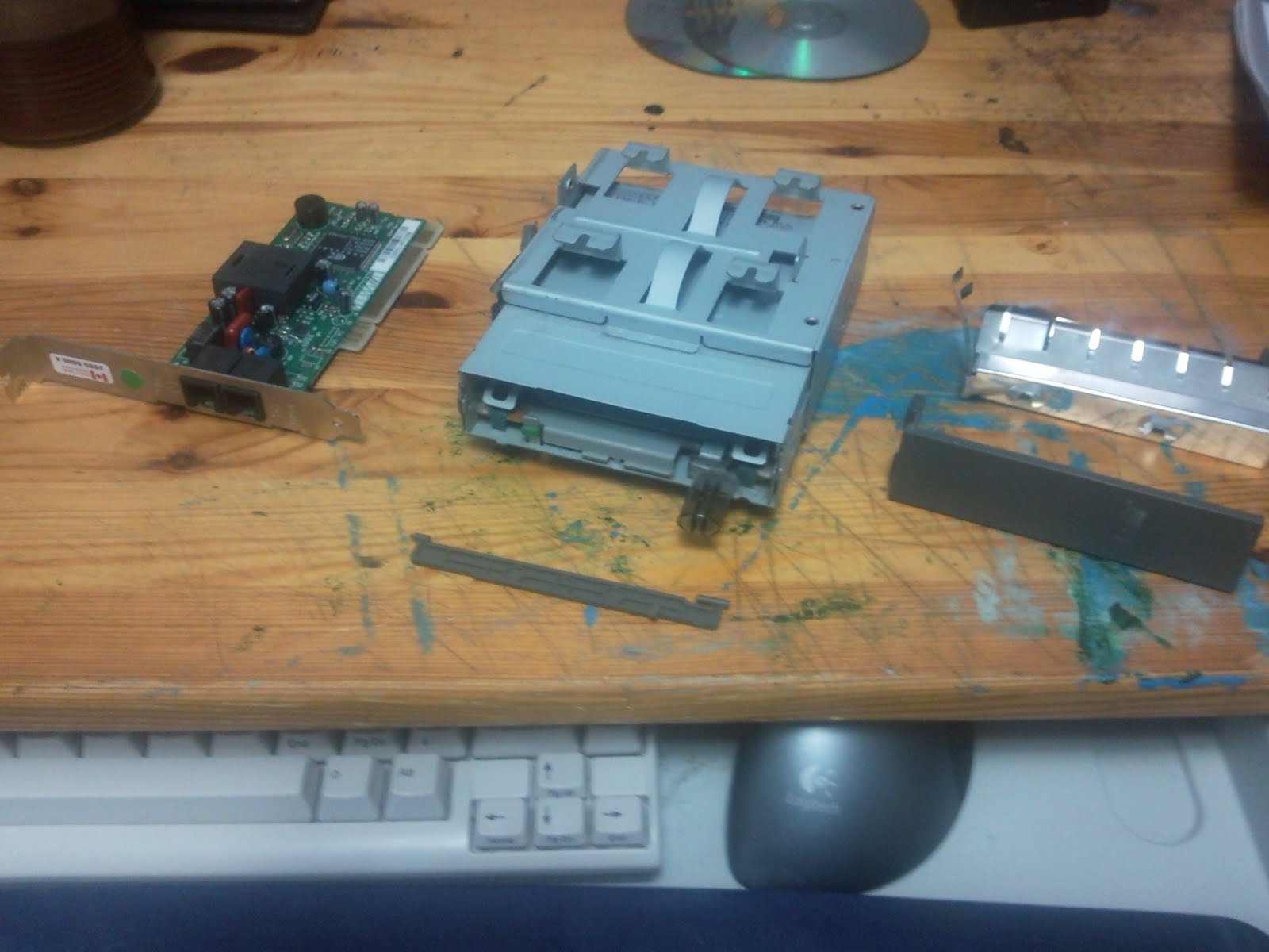 A removed dial-up modem, 3.5 inch floppy drive and a placeholder face-plate